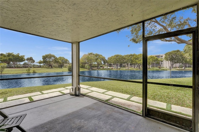 unfurnished sunroom with a water view