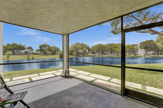 unfurnished sunroom with a water view