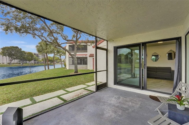 unfurnished sunroom featuring a water view