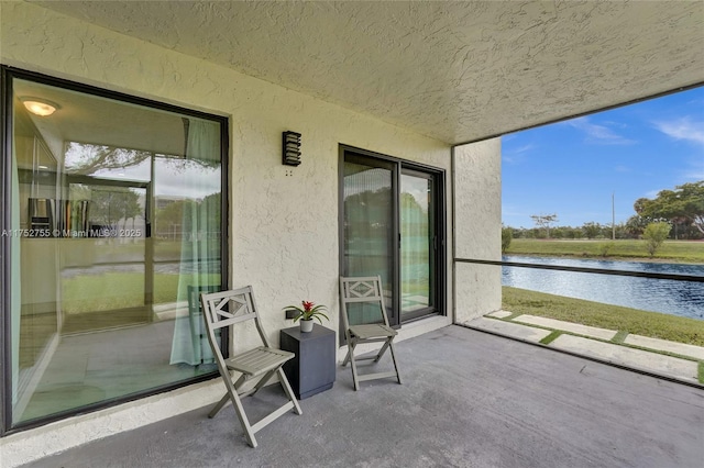 balcony with a patio area and a water view