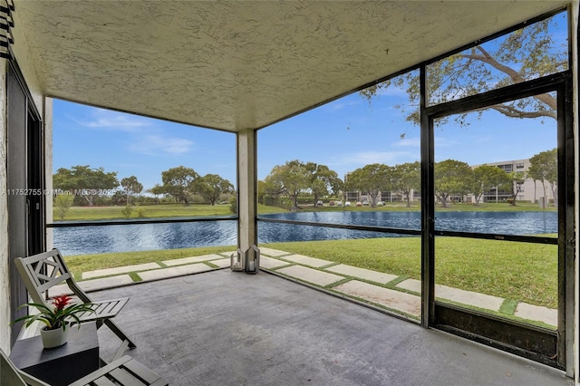 unfurnished sunroom with a water view