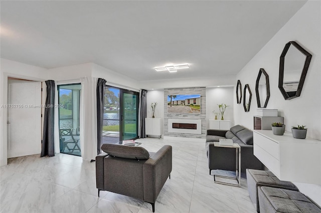 living room featuring a large fireplace and marble finish floor