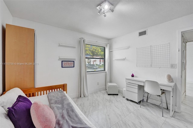 bedroom featuring marble finish floor, visible vents, a textured ceiling, and baseboards