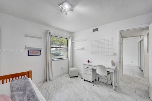 bedroom with a textured ceiling, marble finish floor, visible vents, and baseboards