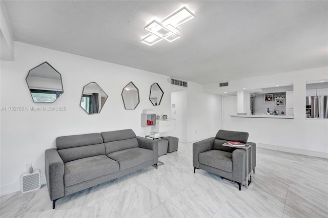 living area with visible vents and baseboards