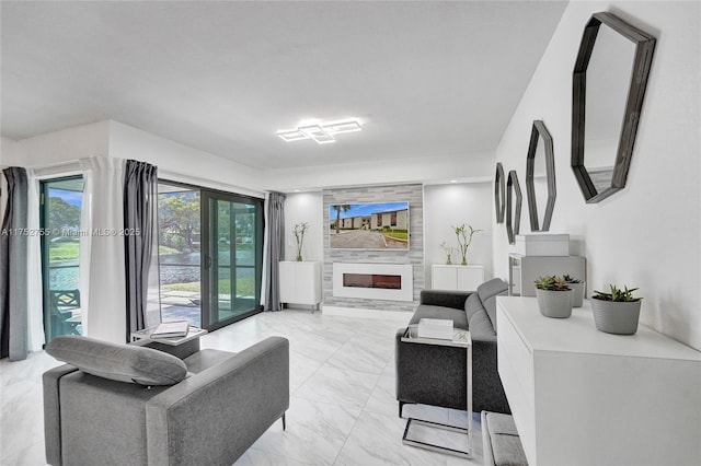 living area featuring a large fireplace and marble finish floor