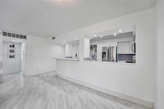 spare room with marble finish floor, recessed lighting, visible vents, and baseboards