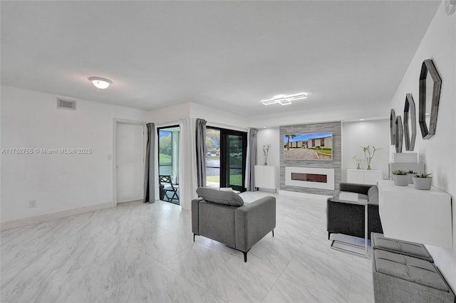 living room featuring a large fireplace, baseboards, visible vents, and marble finish floor