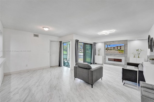 living room with a large fireplace, baseboards, and visible vents