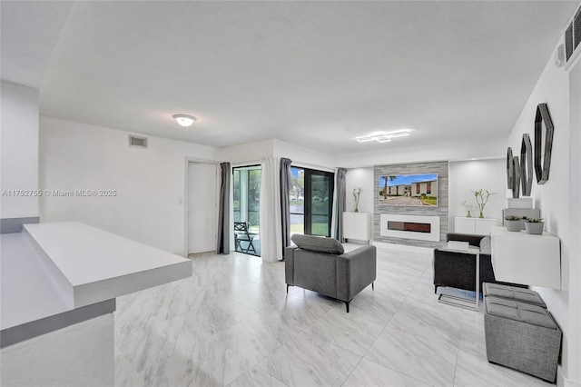 living area featuring marble finish floor, a fireplace, and visible vents