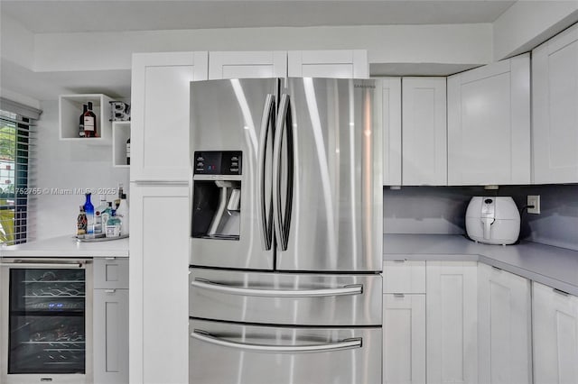 kitchen with open shelves, light countertops, white cabinetry, beverage cooler, and stainless steel fridge with ice dispenser