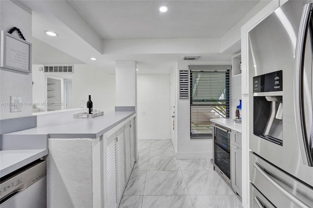 kitchen featuring marble finish floor, visible vents, appliances with stainless steel finishes, and light countertops