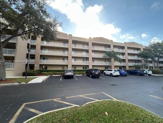 view of building exterior featuring uncovered parking