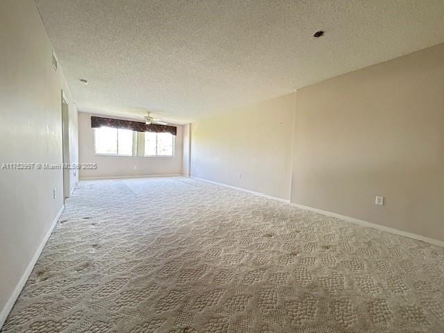 9525 Weldon Cir Unit H403, Fort Lauderdale, FL 33321 - empty room with carpet, a textured ceiling, and baseboards