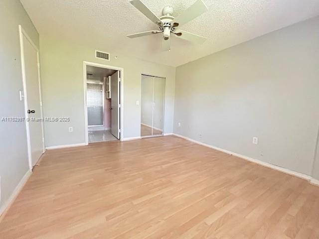 9525 Weldon Cir Unit H403, Fort Lauderdale, FL 33321 - unfurnished bedroom with light wood-type flooring, baseboards, a textured ceiling, a closet, and a ceiling fan