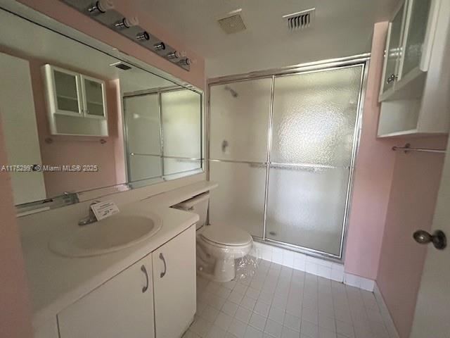 9525 Weldon Cir Unit H403, Fort Lauderdale, FL 33321 - full bathroom with toilet, vanity, a shower stall, and tile patterned floors