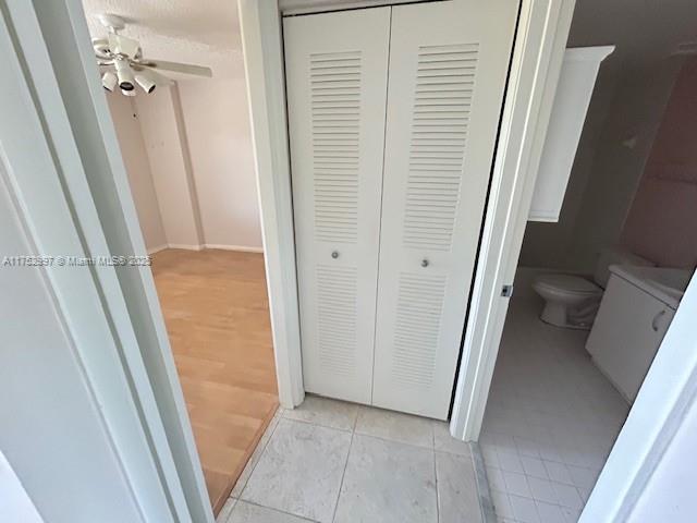 9525 Weldon Cir Unit H403, Fort Lauderdale, FL 33321 - bathroom featuring a closet, toilet, a ceiling fan, tile patterned floors, and baseboards