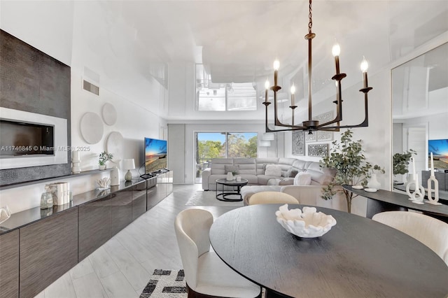 dining area with a high ceiling, visible vents, and a ceiling fan