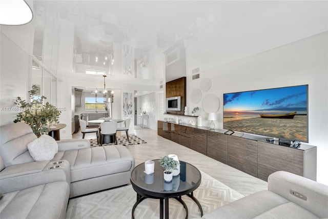 living room with a towering ceiling and an inviting chandelier