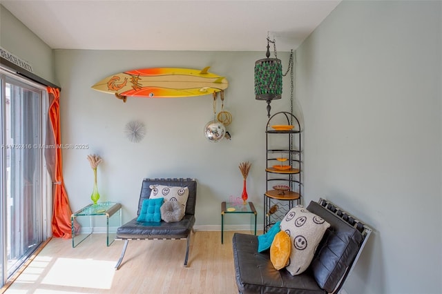 sitting room featuring baseboards and wood finished floors