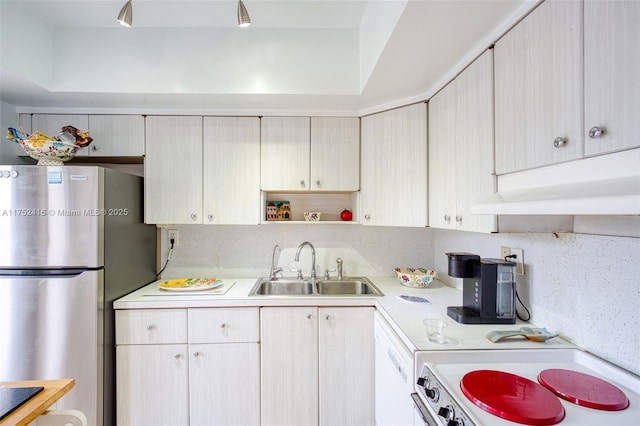 kitchen with white appliances, light countertops, a sink, and decorative backsplash