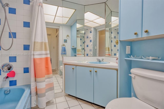 full bath featuring toilet, tile patterned flooring, shower / bath combination with curtain, and vanity