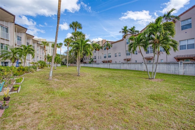 view of yard featuring fence and a residential view