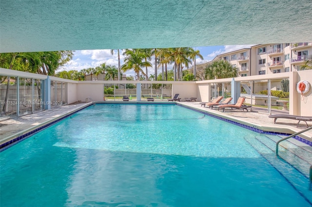 pool featuring a patio and fence