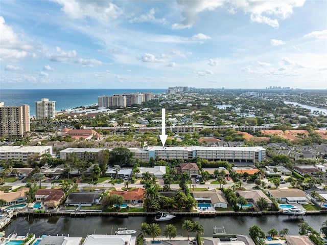 birds eye view of property featuring a view of city and a water view