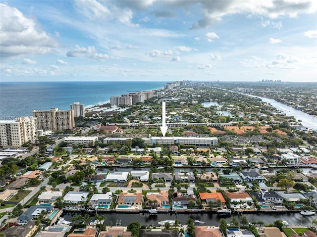 birds eye view of property featuring a water view and a city view