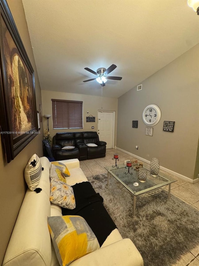 living room featuring baseboards, light tile patterned floors, visible vents, and a ceiling fan