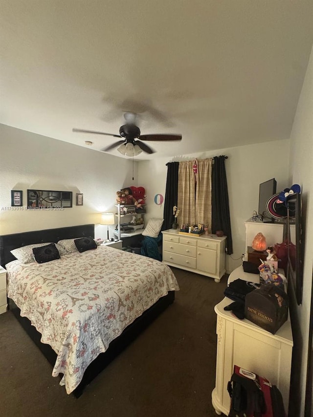 bedroom with ceiling fan and dark colored carpet