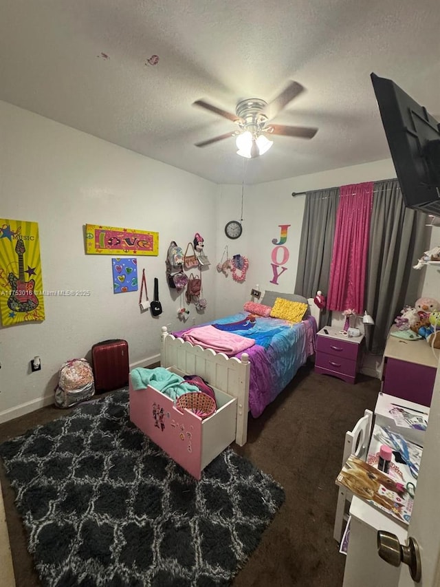 bedroom with a ceiling fan, dark colored carpet, a textured ceiling, and baseboards