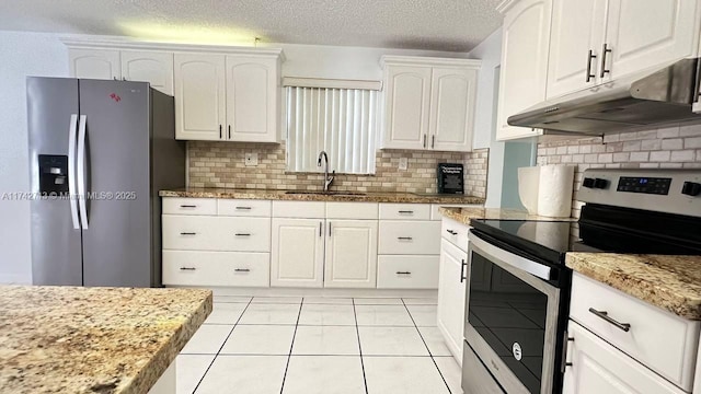 kitchen with under cabinet range hood, white cabinetry, stainless steel appliances, and a sink