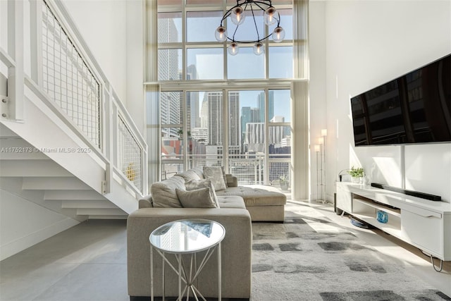 living room with a wall of windows, a towering ceiling, baseboards, and an inviting chandelier