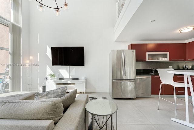 living area with visible vents, baseboards, and light tile patterned floors