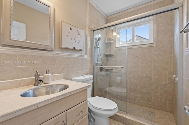 full bathroom featuring toilet, a shower stall, tile walls, and vanity