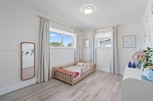 bedroom featuring light wood-type flooring and baseboards