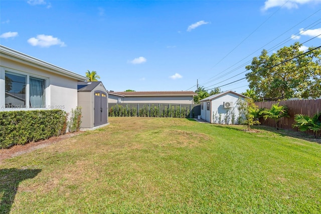 view of yard with a storage unit, an outdoor structure, and a fenced backyard