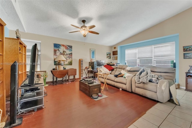 8601 Bridle Path Ct Unit 222, Davie, FL 33328 - living area featuring ceiling fan, a textured ceiling, baseboards, vaulted ceiling, and light wood-style floors