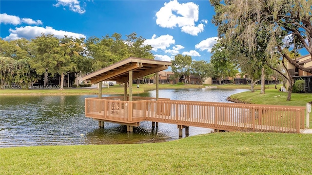 view of dock featuring a lawn and a water view