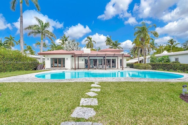 view of swimming pool with a yard and a fenced in pool