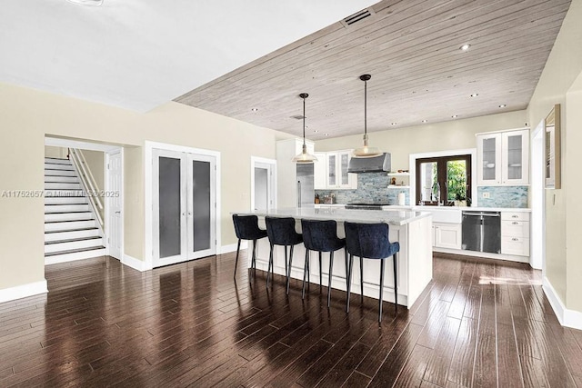 kitchen with glass insert cabinets, white cabinets, decorative light fixtures, and french doors