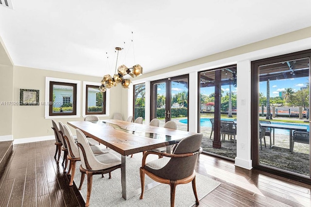 dining space featuring french doors, hardwood / wood-style floors, and a wealth of natural light