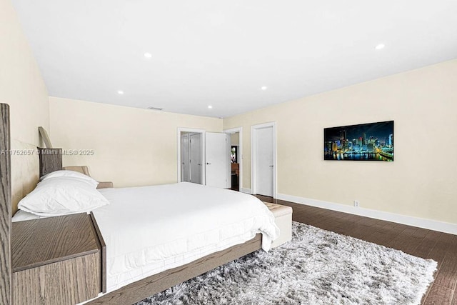 bedroom featuring baseboards, dark wood finished floors, and recessed lighting