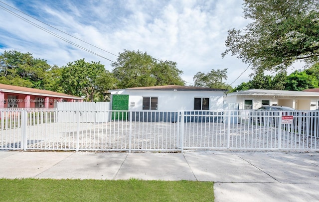 ranch-style house with a fenced front yard and stucco siding