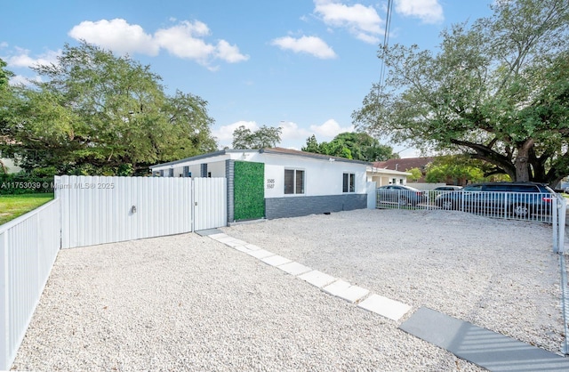 view of outbuilding featuring a gate, fence, and driveway