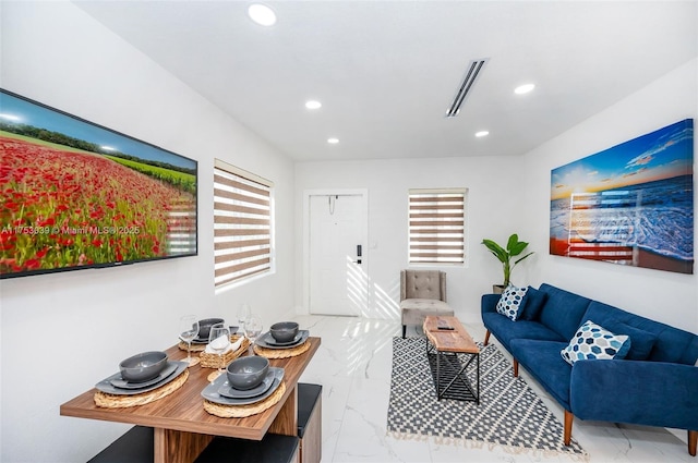 living area featuring marble finish floor, visible vents, and recessed lighting