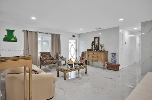 living room with recessed lighting, marble finish floor, and visible vents