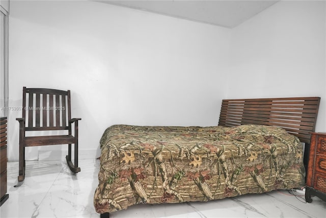 bedroom featuring marble finish floor